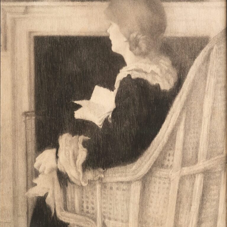 Woman sitting in armchair by fireplace with back turned to viewer. Book in right hand.
