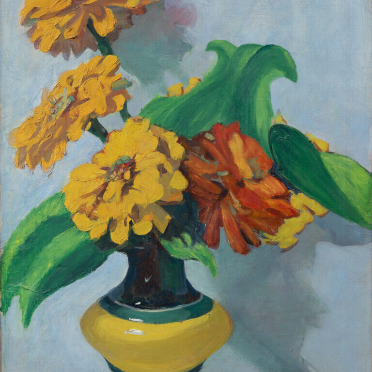 Jane Peterson paints a vase of large yellow zinnias surrounded by dramatic green leaves against a blue background in her oil painting “Zinnias in a Yellow Vase.” 